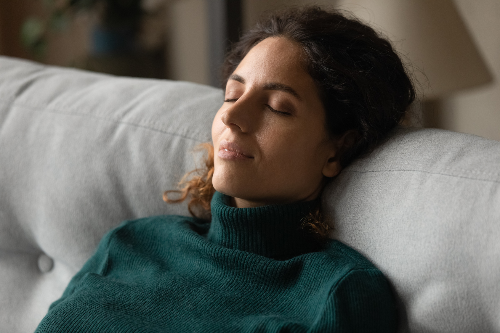 Woman resting with eyes closed during a monitored session, ketamine therapy in Maryland