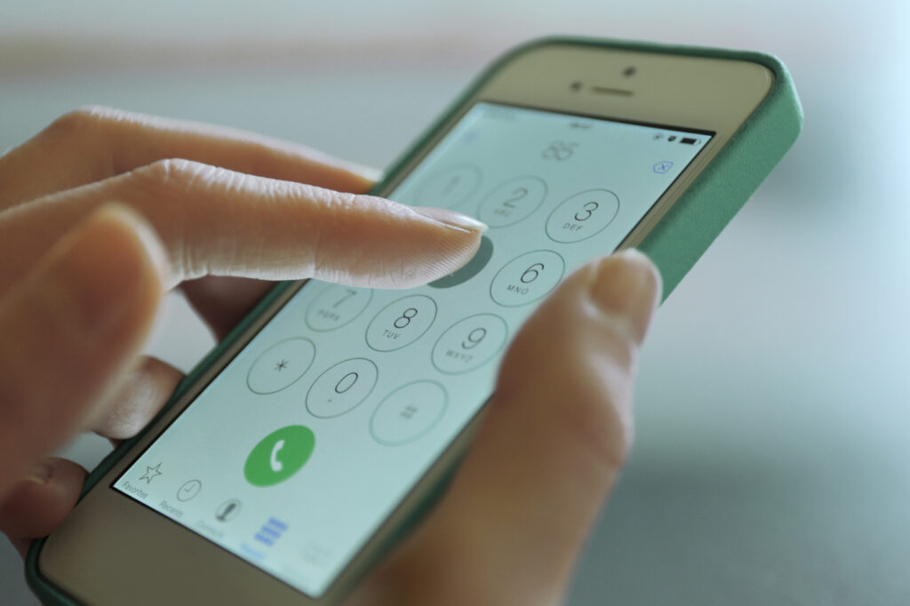 Finger dialing a crisis line on a smartphone, crisis options in Montgomery County MD