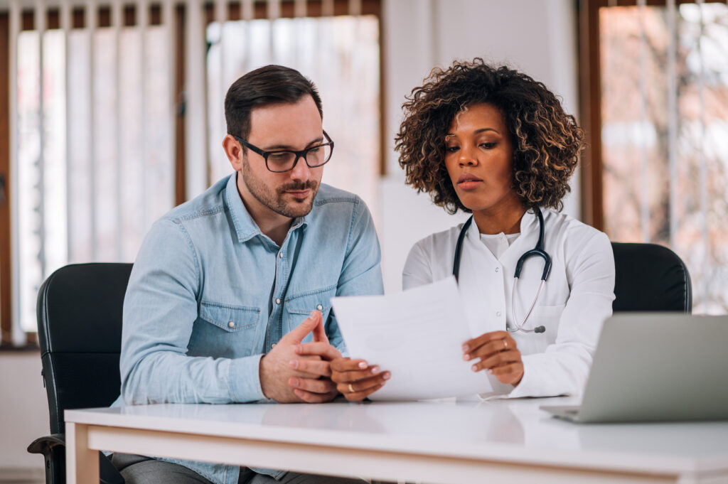 Clinician and patient reviewing past treatment records together during a second opinion psychiatrist visit